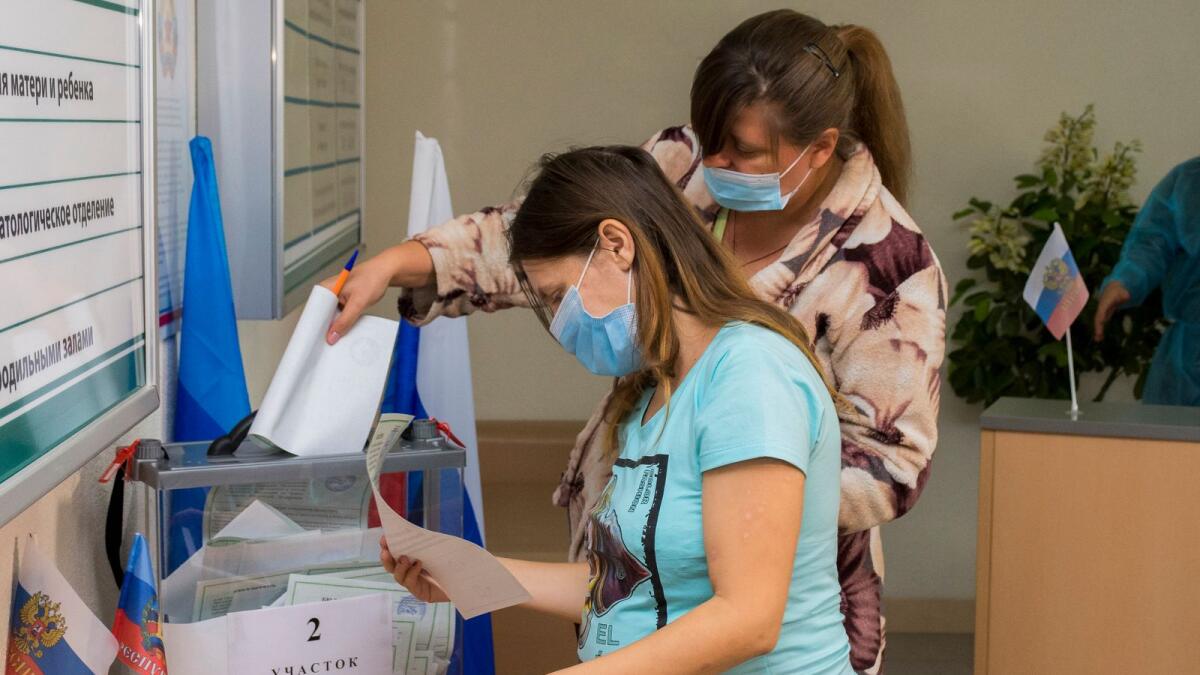 Women vote at a polling station in a maternity hospital during a referendum in Luhansk, eastern Ukraine, on Sunday. — AP