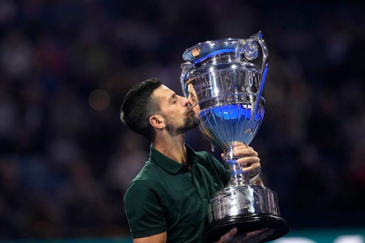 Serbia's Novak Djokovic kisses the ATP trophy after finishing the year as the world's number one player. — AP