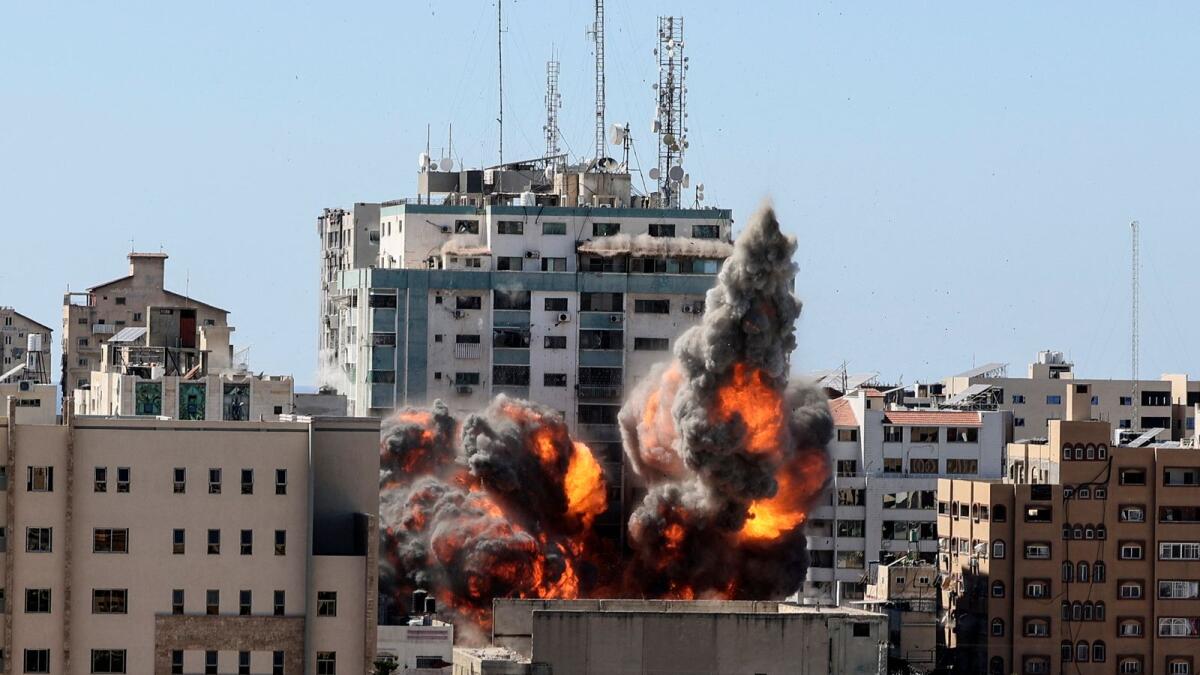 A ball of fire erupts from the Jala Tower as it is destroyed in an Israeli air strike in Gaza city. Photo:  AFP