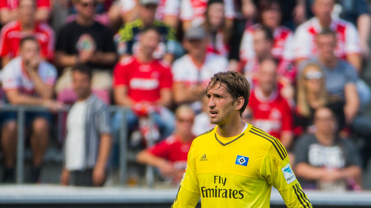Hamburg' s  goalie  Rene Adler  leaves the match because of an injury, challenges during the German first division Bundesliga soccer match between 1. FC Cologne and Hamburger SV in Cologne, Germany, Saturday Aug. 29, 2015.  (Rolf Vennenbernd/dpa via AP)