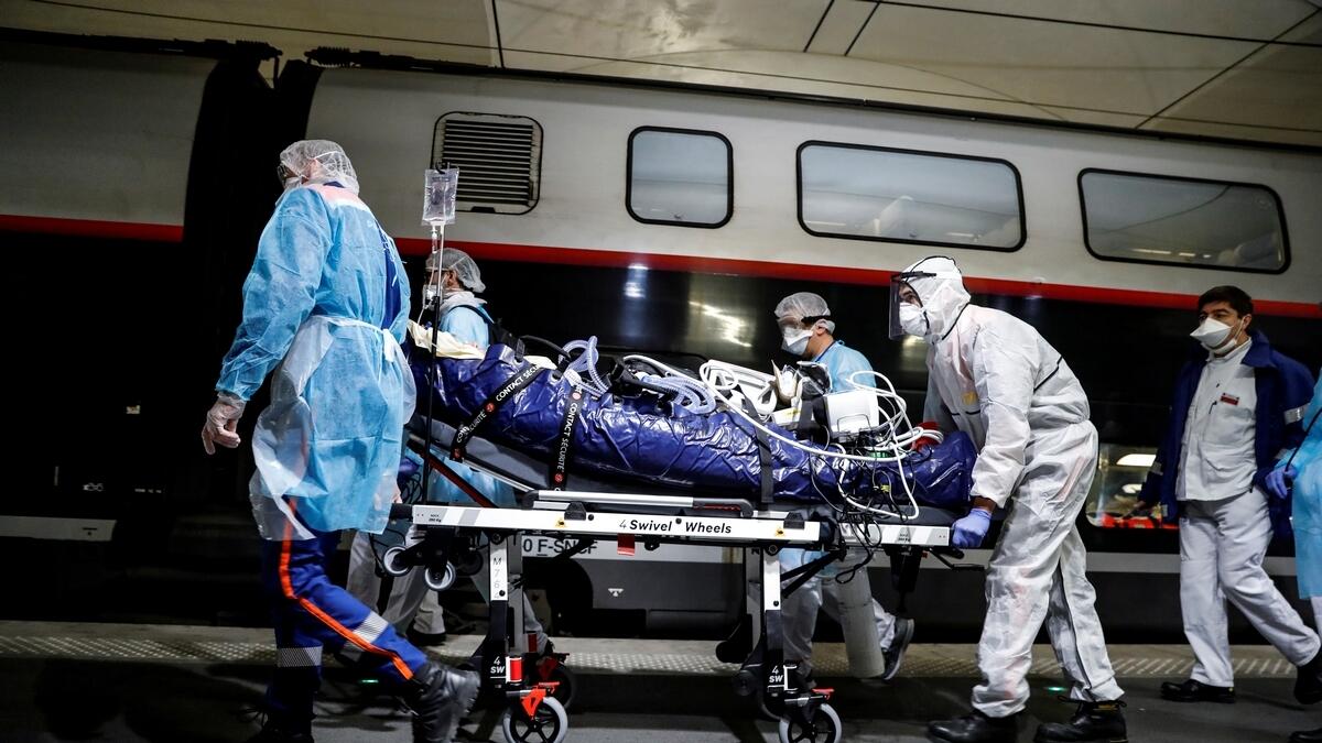 Medical staff embark a patient infected with the COVID-19 onboard a TGV high speed train at the Gare d'Austerlitz train station, to evacuate some of the coronavirus disease patients from Paris region hospitals to Brittany, in Paris, France April 1, 2020