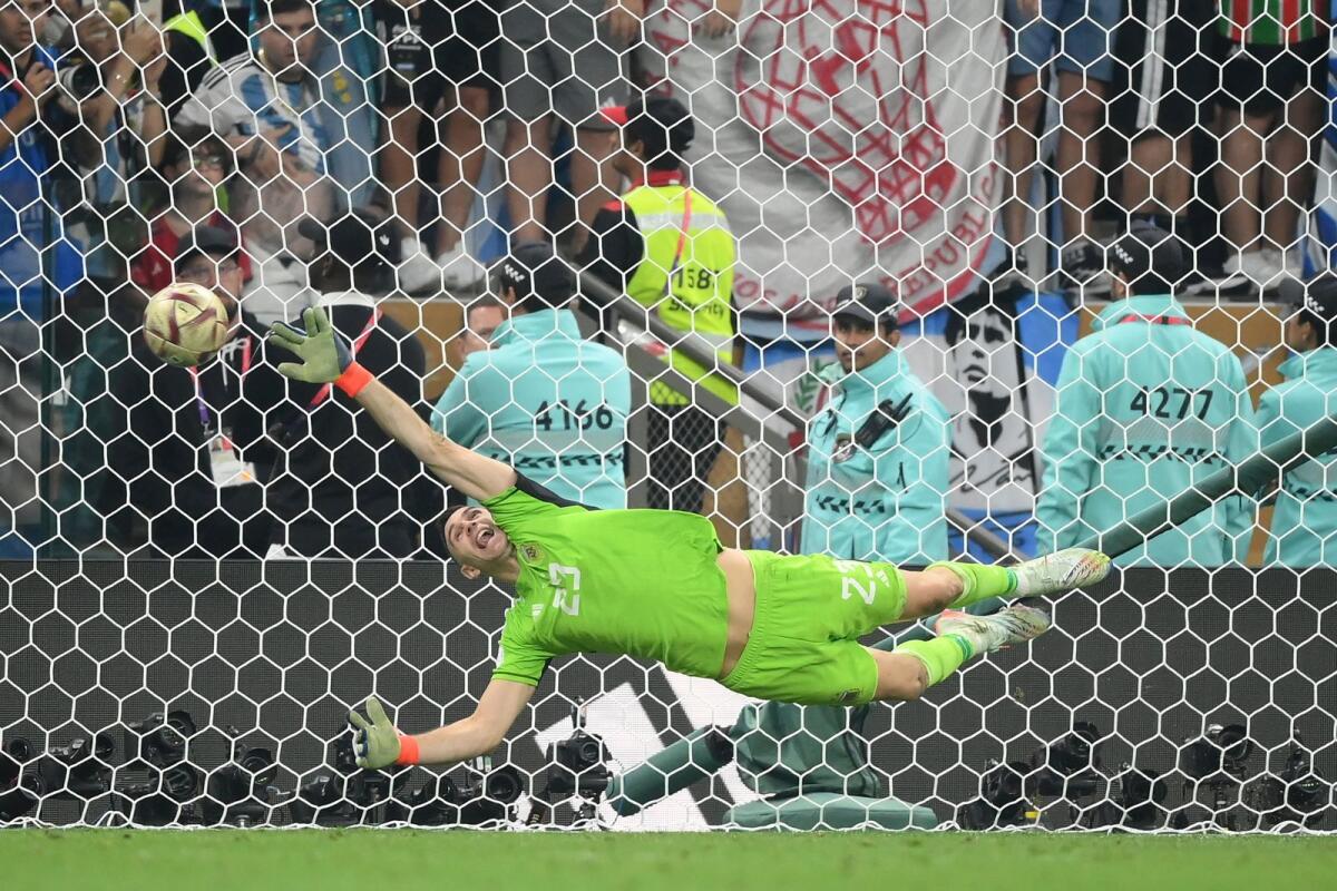Argentina's goalkeeper Emiliano Martinez saves a crucial penalty during the shootout in the World Cup final against France. (AFP)