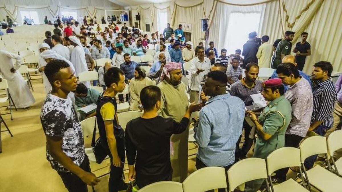 Officers assisting amnesty seekers on the first day at Al Awir immigration centre in Dubai on Wednesday.