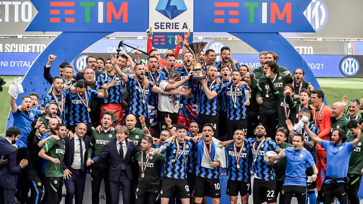 Inter Milan players celebrate with the trophy clinching the Serie A title, after the match between against Udinese. — AP