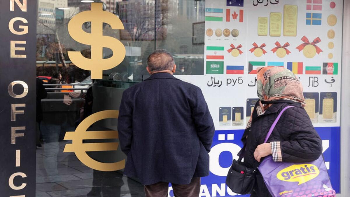 People look at exchange rates outside an exchange office in Ankara. The biggest annual rise in consumer prices was in the transportation sector, up 119.11 per cent, while food and non-alcoholic drinks prices climbed 94.65 per cent. — File photo
