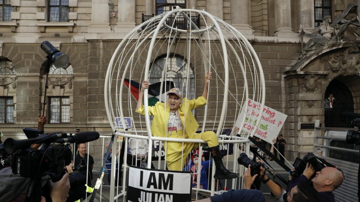 Fashion designer Vivienne Westwood stands in a giant bird cage in protest against the extradition of WikiLeaks founder Julian Assange to the US, outside the Old Bailey court, in London. Photo: AP