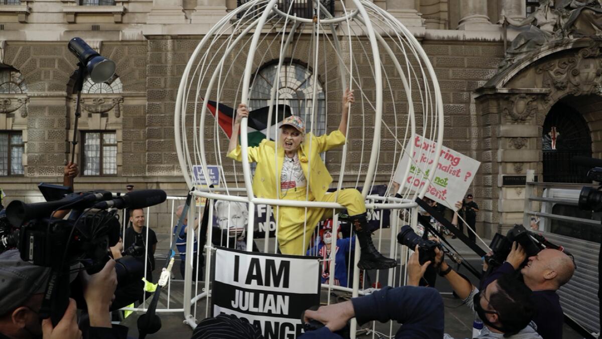 Fashion designer Vivienne Westwood stands in a giant bird cage in protest against the extradition of WikiLeaks founder Julian Assange to the US, outside the Old Bailey court, in London. Photo: AP