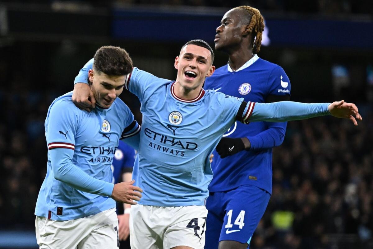 Manchester City's Julian Alvarez (left) celebrates with Phil Foden after scoring their second goal from the penalty spot. — AFP