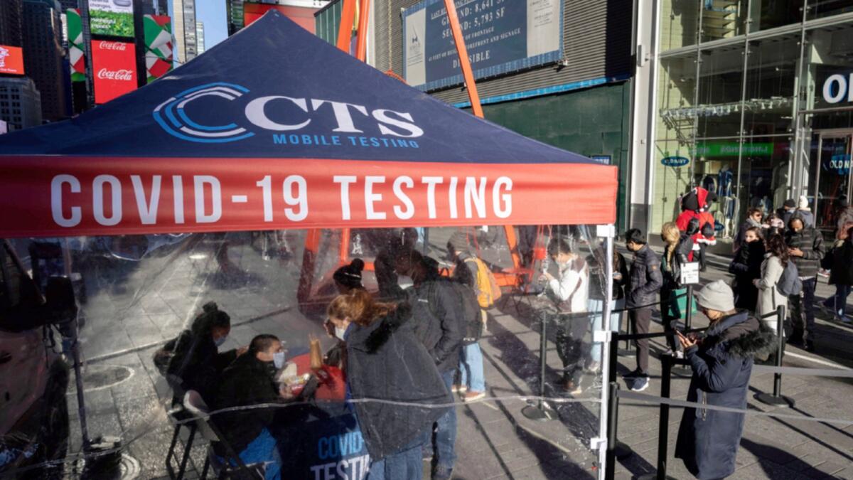 People wait in line at Covid-19 testing site in Times Square. — AP