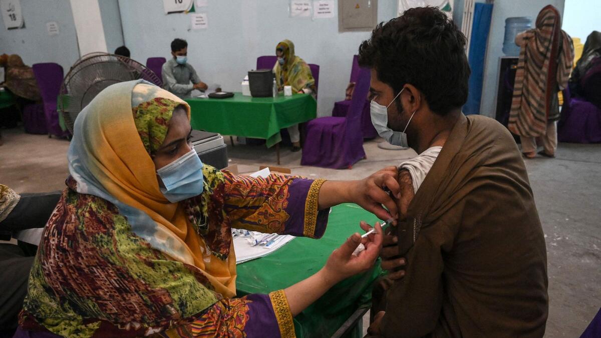 A man receives a dose of the Sinovac vaccine at a health centre in Lahore.