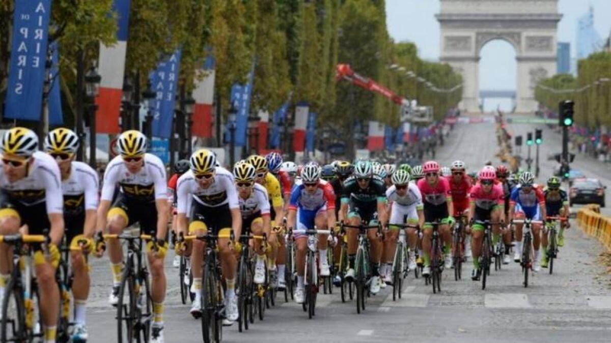 Riders race in front of the Arc de Triomphe during the Tour de France. - Agencies