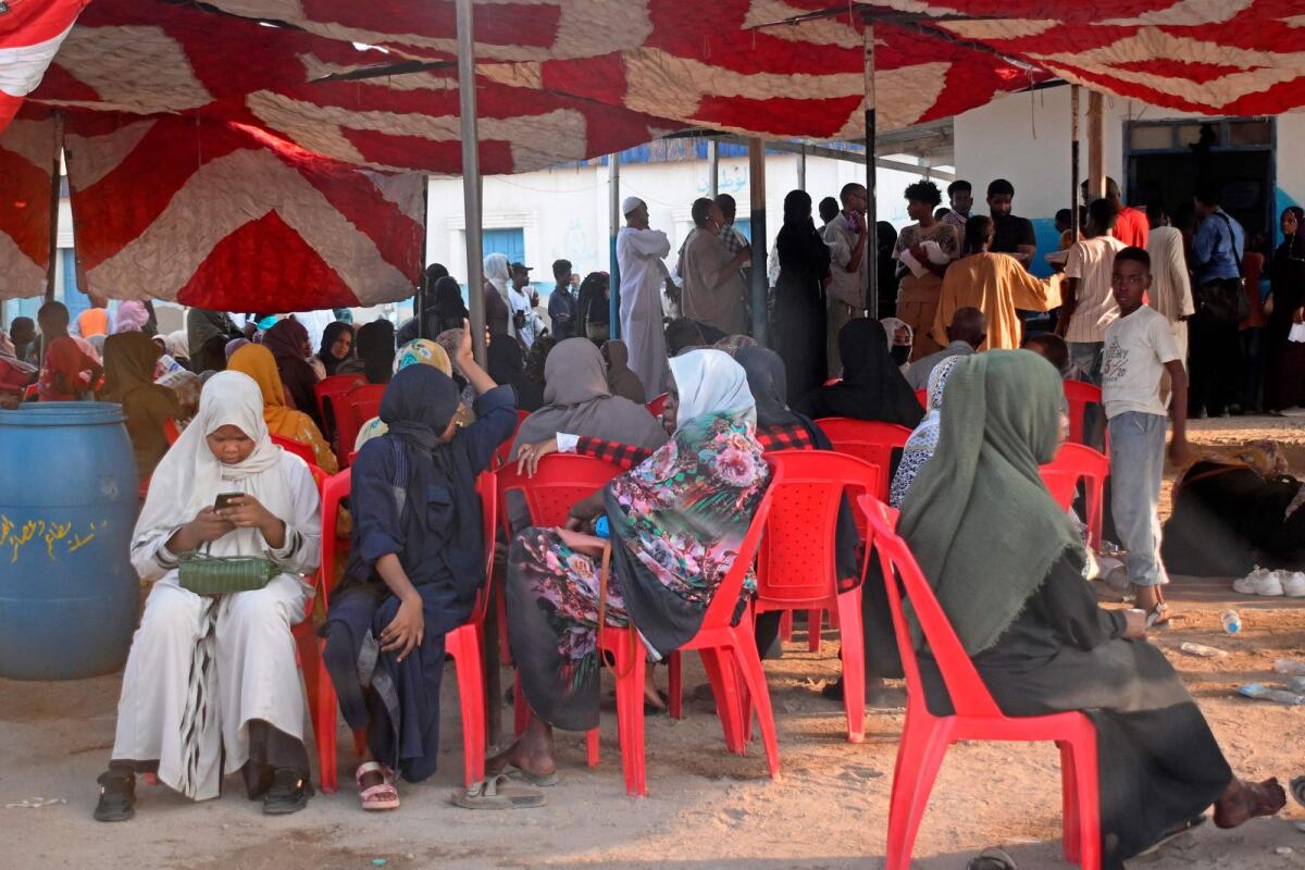 Sudanese wait outside a Passports and Immigration Services office in Port Sudan on September 3, 2023, following an announcement by the authorities of the resumption of issuing travel documents in war-torn Sudan. – AFP photos