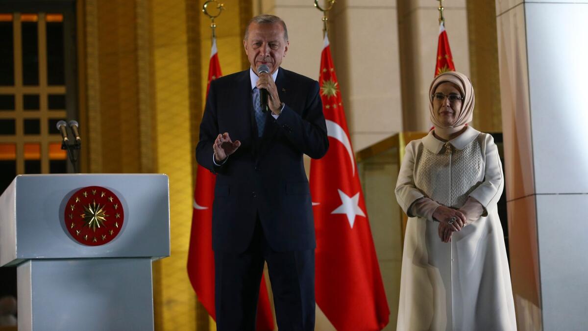 Turkish President Recep Tayyip Erdogan makes a speech next to his wife, Emine, at the presidential palace, in Ankara, Turkey, on Sunday.  AP