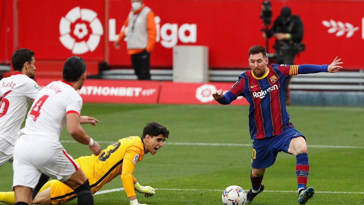 Barcelona's Lionel Messi scores a goal during a Spanish La Liga match against Sevilla on Saturday. — AP