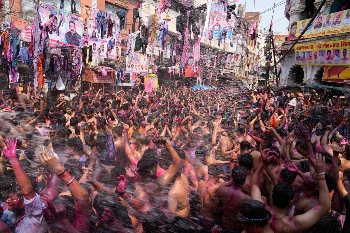 Revellers dance during celebrations to mark Holi in Prayagraj, northern Uttar Pradesh state, India, on Monday. — AP