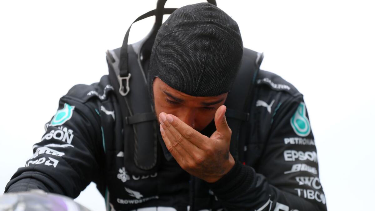 Mercedes' British driver Lewis Hamilton reacts as he gets out of his car after winning the Turkish Formula One Grand Prix. — AFP