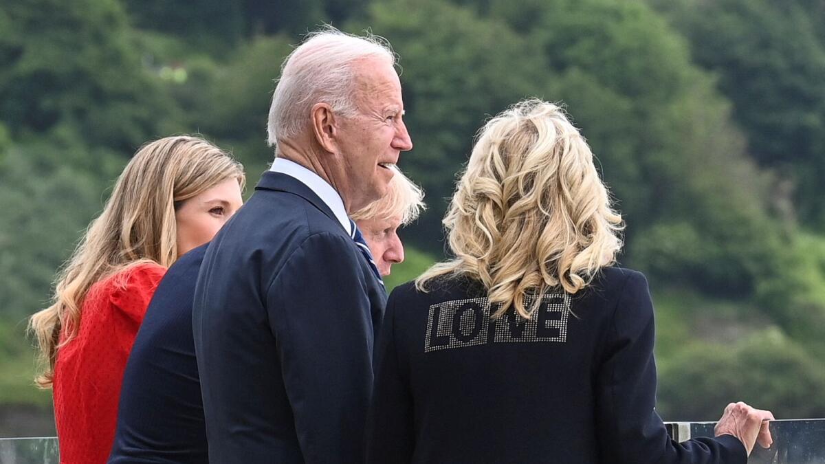 Britain's Prime Minister Boris Johnson (2R), his wife Carrie Johnson (L) and US President Joe Biden and US First Lady Jill Biden, wearing a jacket bearing the words 'love', look out over the sea, prior to a meeting at Carbis Bay, Cornwall, on Thursday.