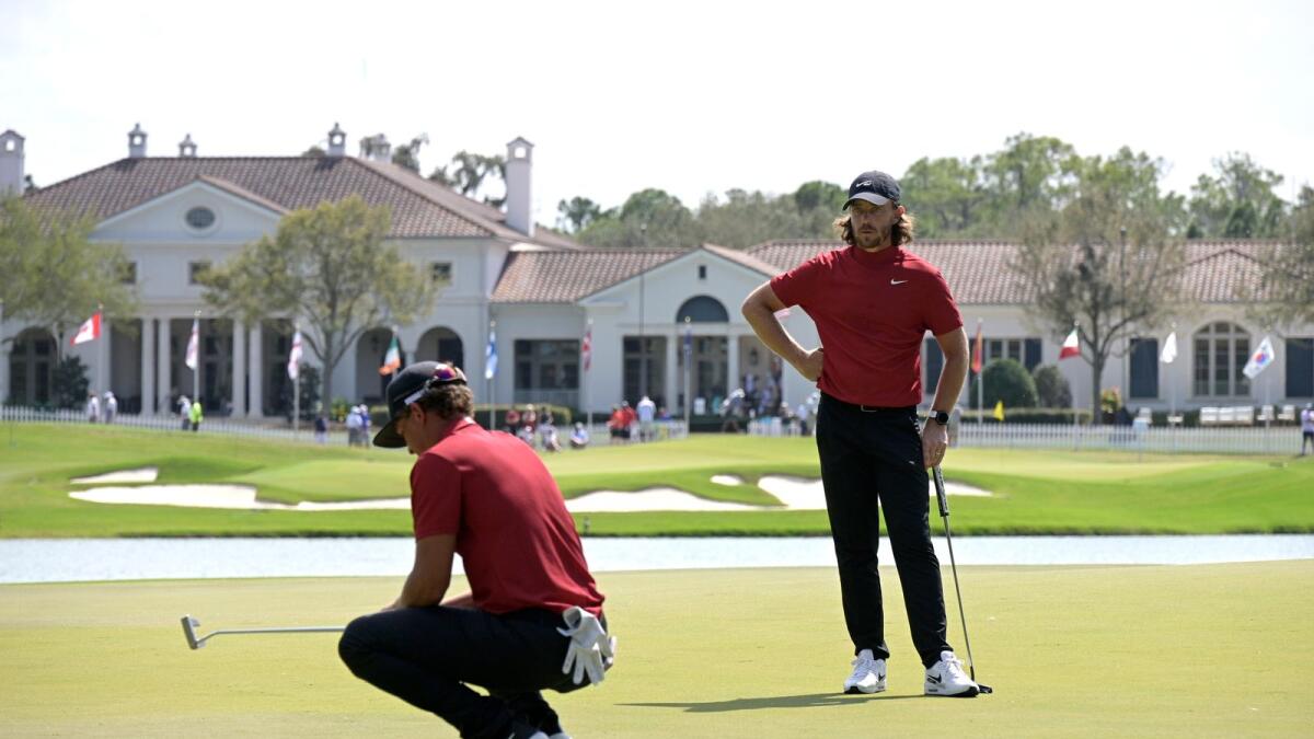 Tommy Fleetwood of England watches as Cameron Champ lines up a putt on the 10th green during the final round of the Workday Championship golf tournament. — AP