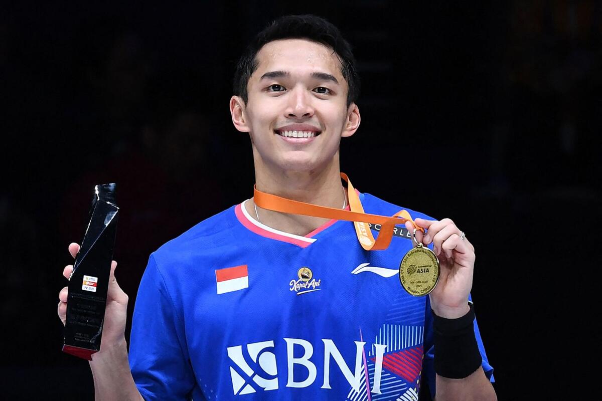 Indonesia's Jonatan Christie poses on the podium after winning the men's singles final match against China's Li Shifeng. — AFP