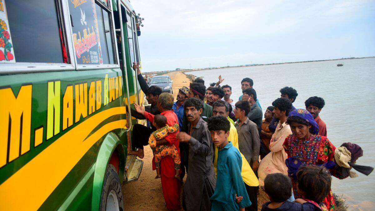 Residents evacuate from a coastal area of Keti Bandar before the due onset of cyclone Biparjoy, in Thatta district of Pakistan's Sindh province, on June 13, 2023. — AFP