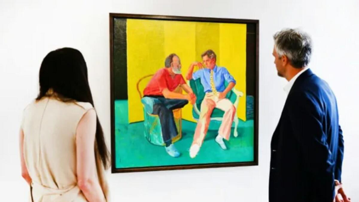 Christies senior specialist and senior vice president Alex Marshall views 'The Conversation' by David Hockney on display at Christie's Los Angeles