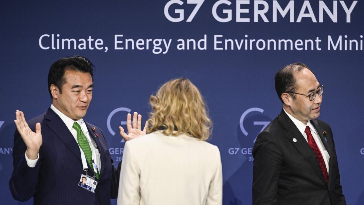 Japan's State Minister of Environment Toshitaka Ooka speaks to German Minister for the Environment, Nature Conservation, Nuclear Safety and Consumer Protection Steffi Lemke next to Japan's Minister for Economic Affairs, Trade and Industry Kenichi Hosoda during the G7 meeting in Berlin. AFP
