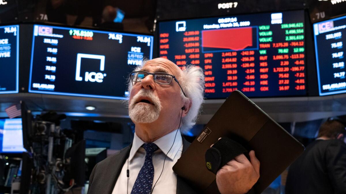 Trader Peter Tuchman works on the floor of the New York Stock Exchange. Steady growth and resilience in the face of the coronavirus pandemic made technology stocks desirable to investors, who poured money into the sector as widespread lockdowns devastated swaths of the US economy. — AP file