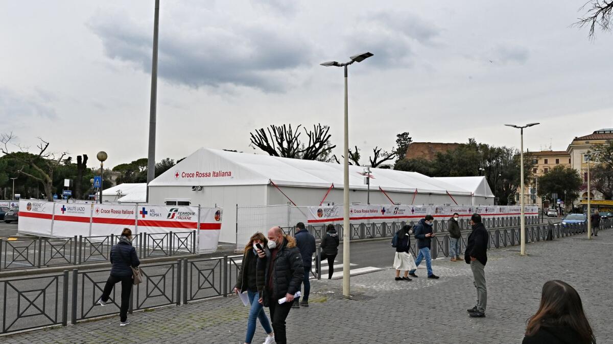 People walk in front of a make-shift vaccination centre outside Rome's Termini train station in Rome. Photo: AFP