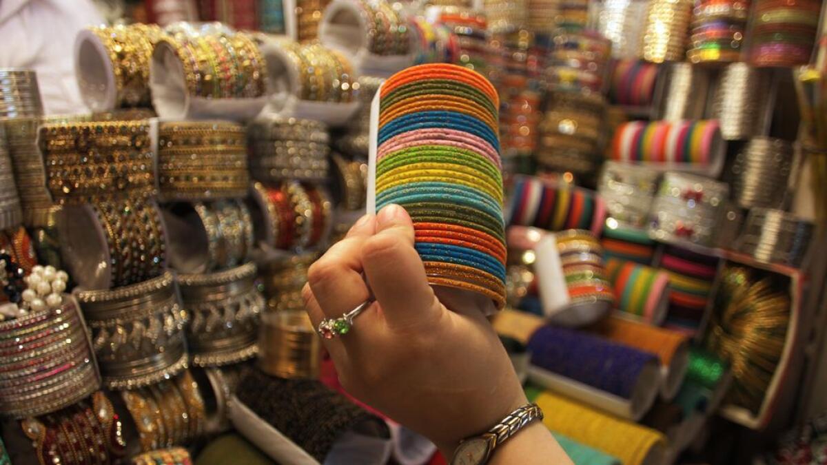 A woman browses to buy traditional bangles for the upcoming Eid al-Fitr holiday to mark the end of the holy fasting month of Ramadan in Lahore, Pakistan,
