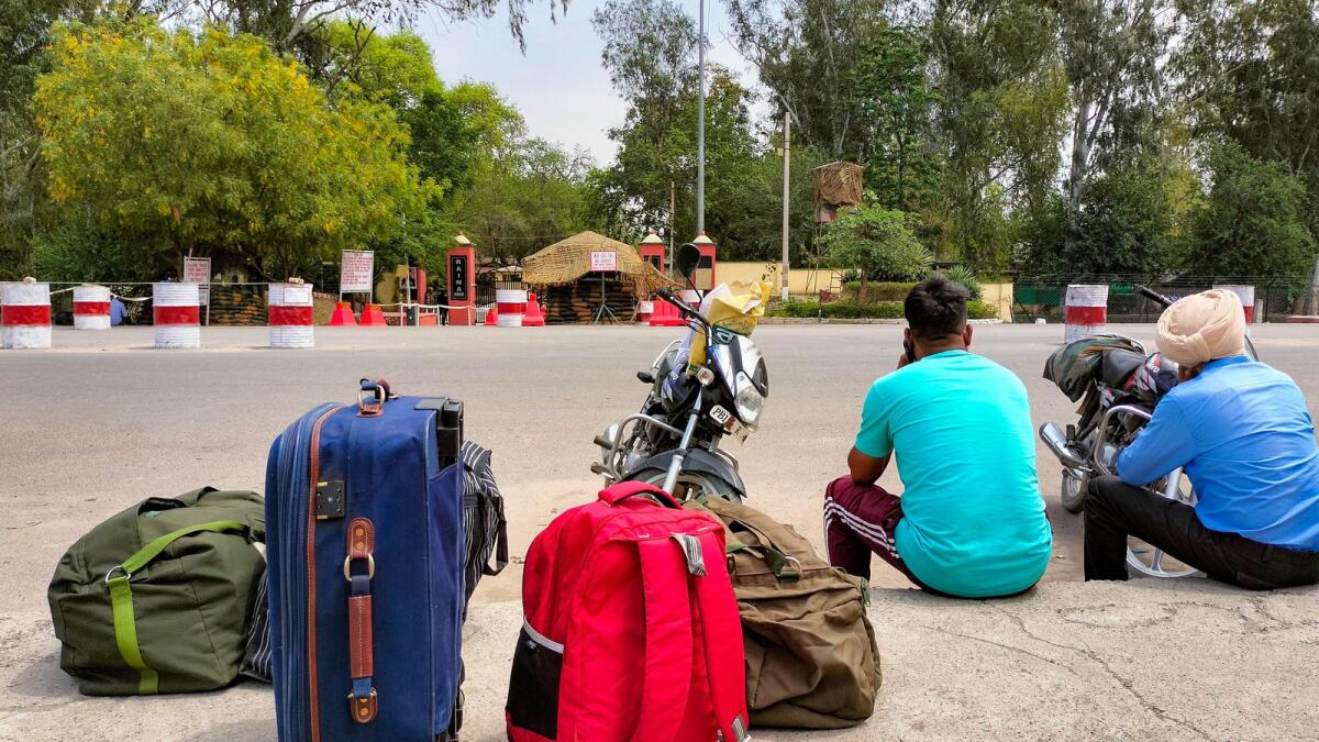 Soldiers, who returned after leave, wait outside the Bathinda military station after a firing incident took place on Wednesday morning. — PTI