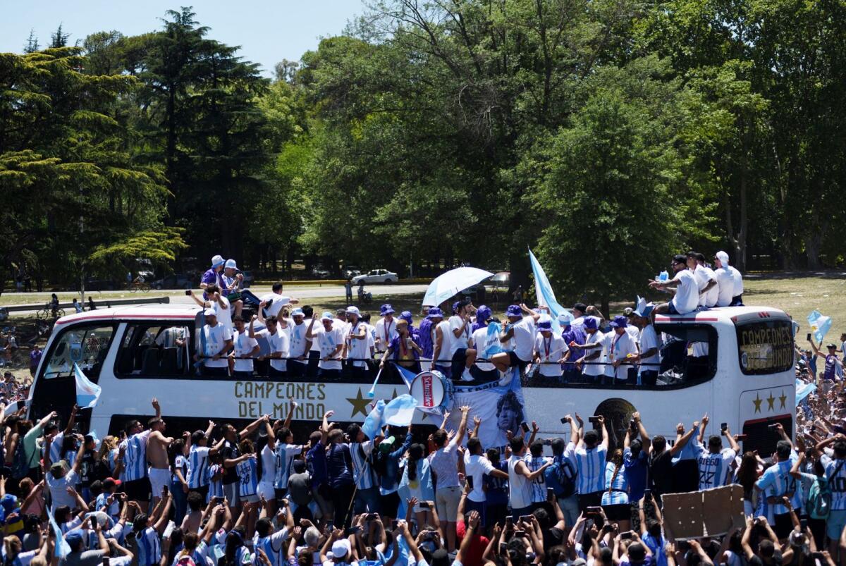 Argentina players are pictured on a bus during the victory parade as fans celebrate (Photo: Reuters)
