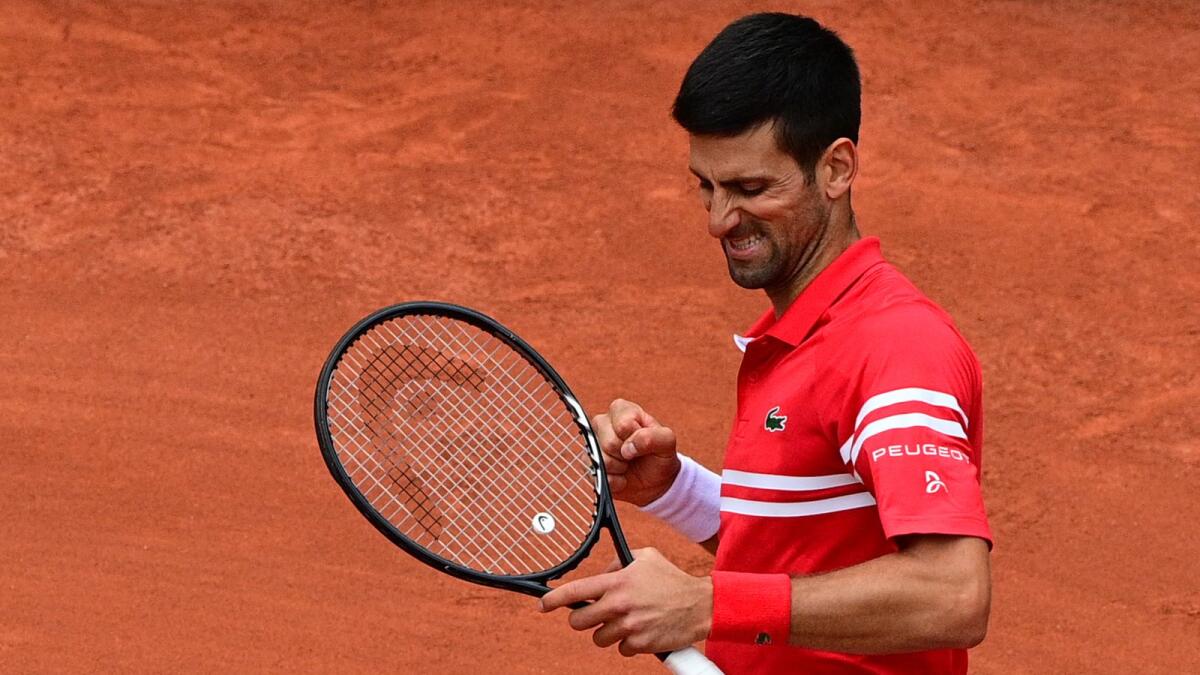Novak Djokovic celebrates after winning against Lithuania's Ricardas Berankis. — AFP