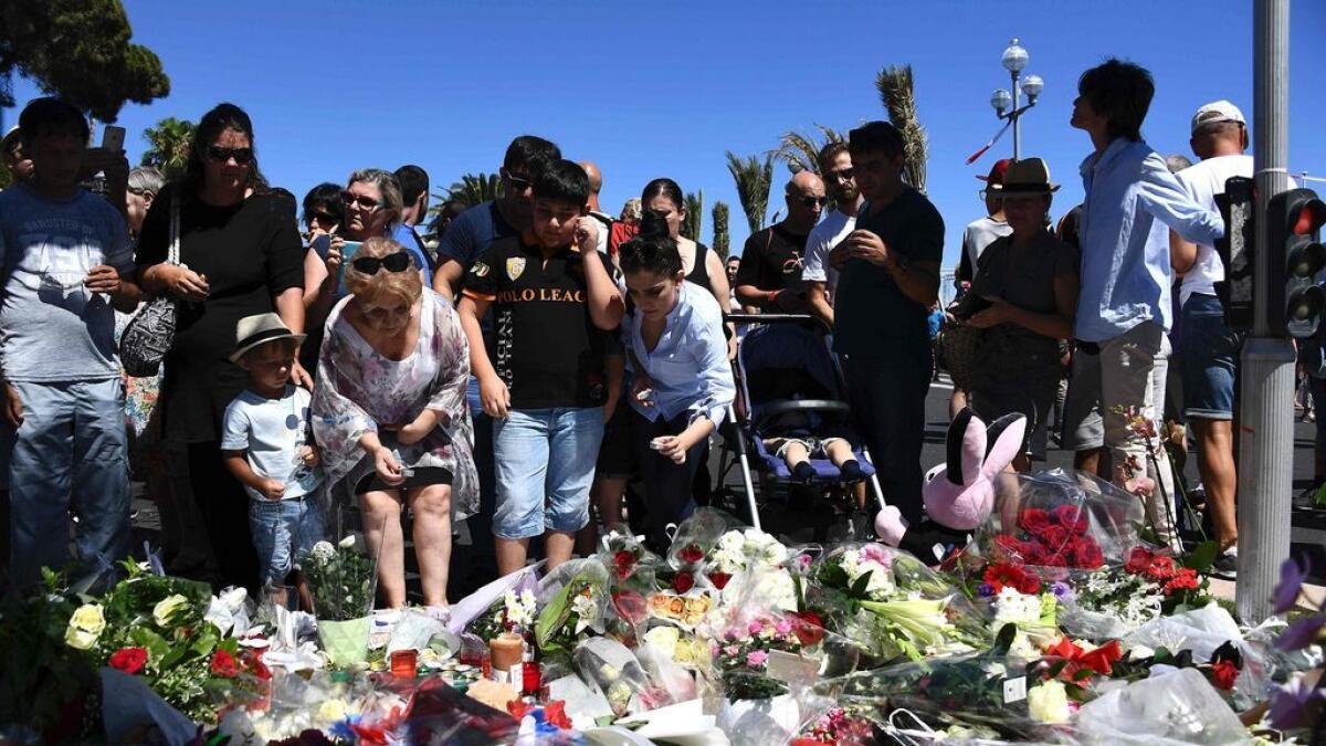 People lay flowers in the street of Nice to pay tribute to the victims of the Nice truck attack