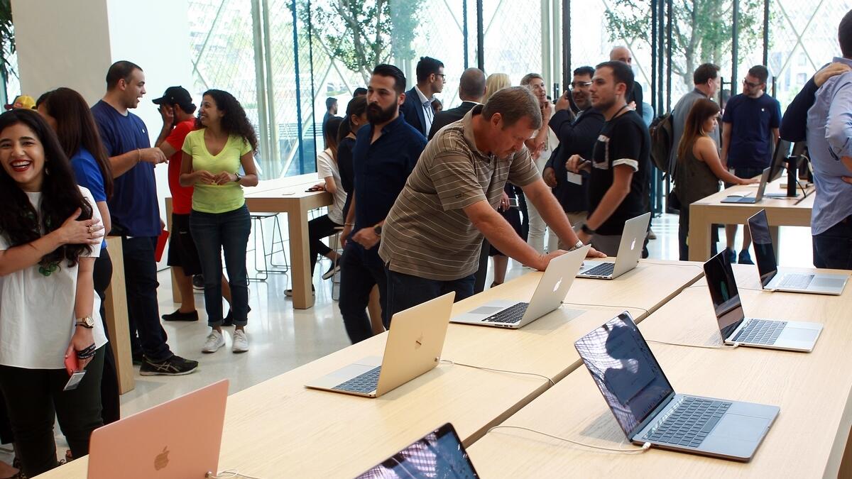 Customers check Apple gadgets in the newly opened Apple store in Dubai Mall.