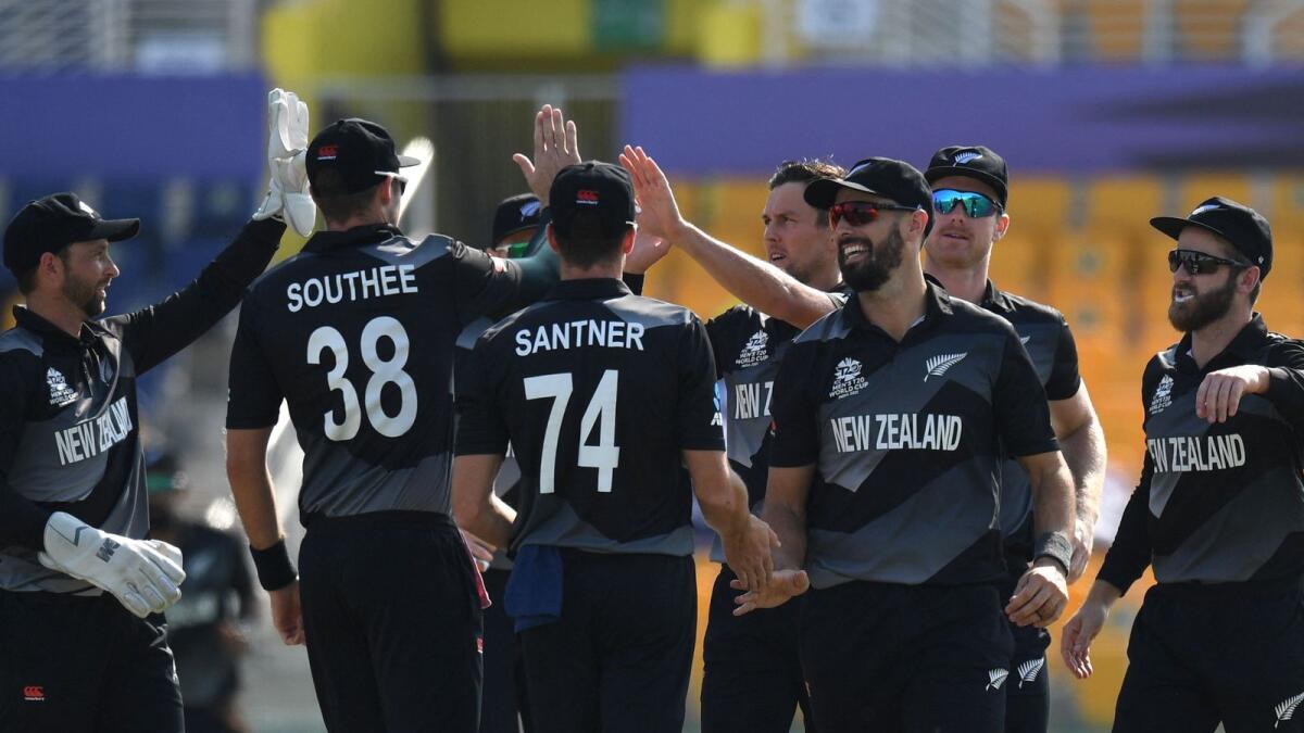 New Zealand players celebrate the wicket of Afghanistan's Hazratullah Zazai. (AFP)