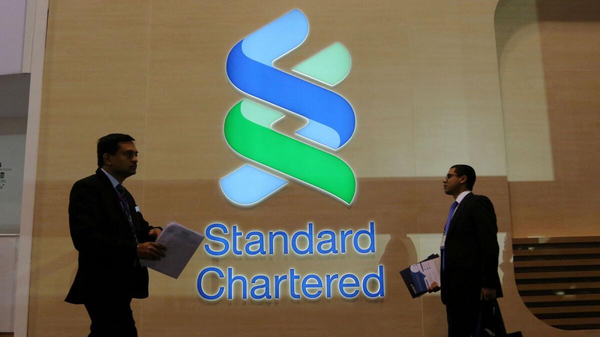 People pass by the logo of Standard Chartered at the SIBOS banking and financial conference in Toronto, Ontario, Canada. — Reuters