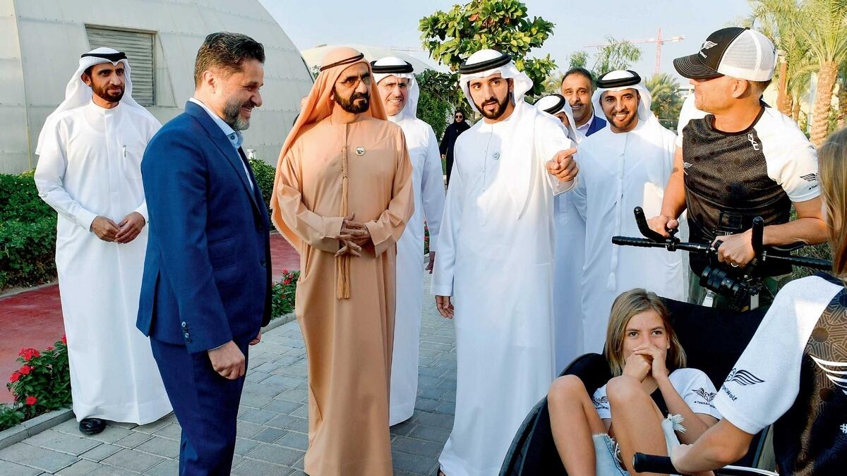 Sheikh Mohammed, Sheikh Hamdan and other officials interact with people during the visit to The Sustainable City on Thursday. — Wam