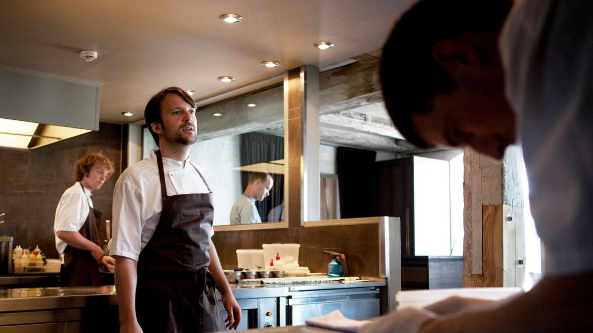 Rene Redzepi, center, chef of Noma who practices a earthly style of cooking known as 'new Nordic,' works in the kitchen at the restaurant in Copenhagen, June 21, 2010.
