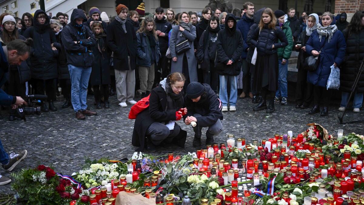 Mourners lay candle lights outside the headquarters of Charles University for victims of mass shooting in Prague. — AP