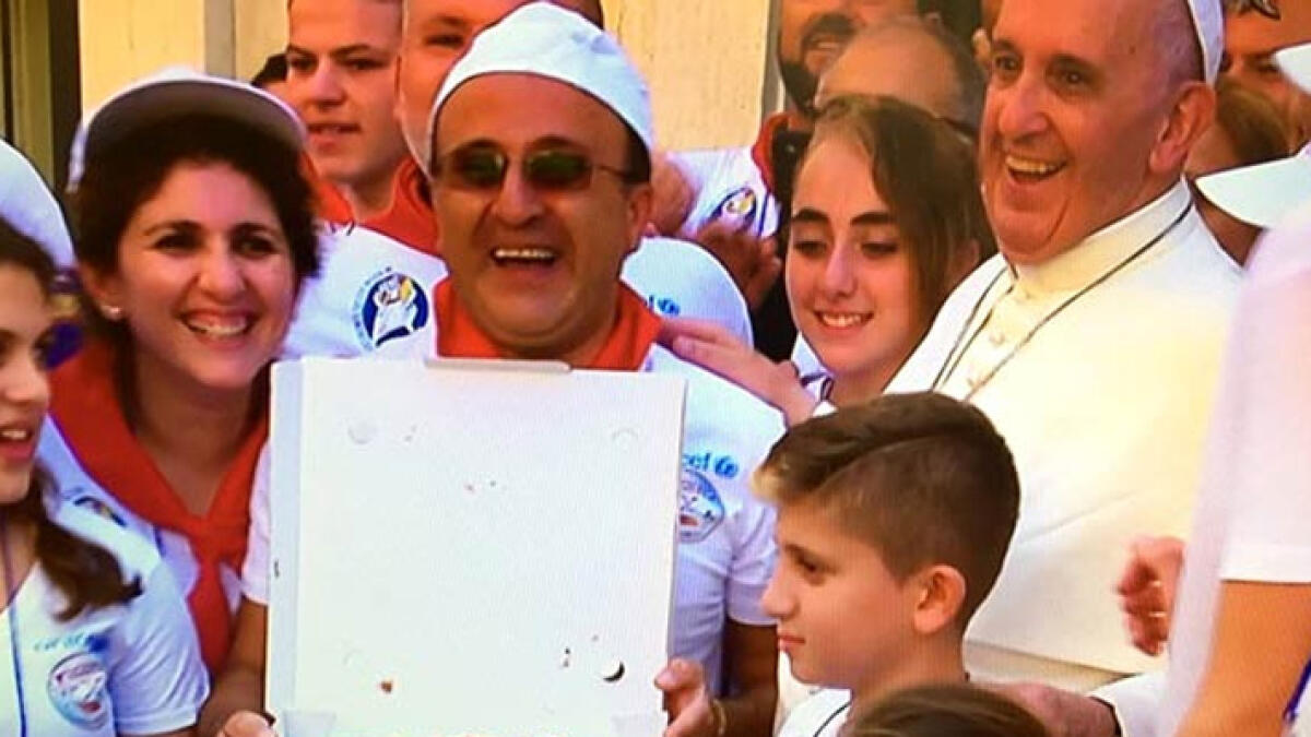 WATCH: Pope Francis shares pizza lunch with the poor