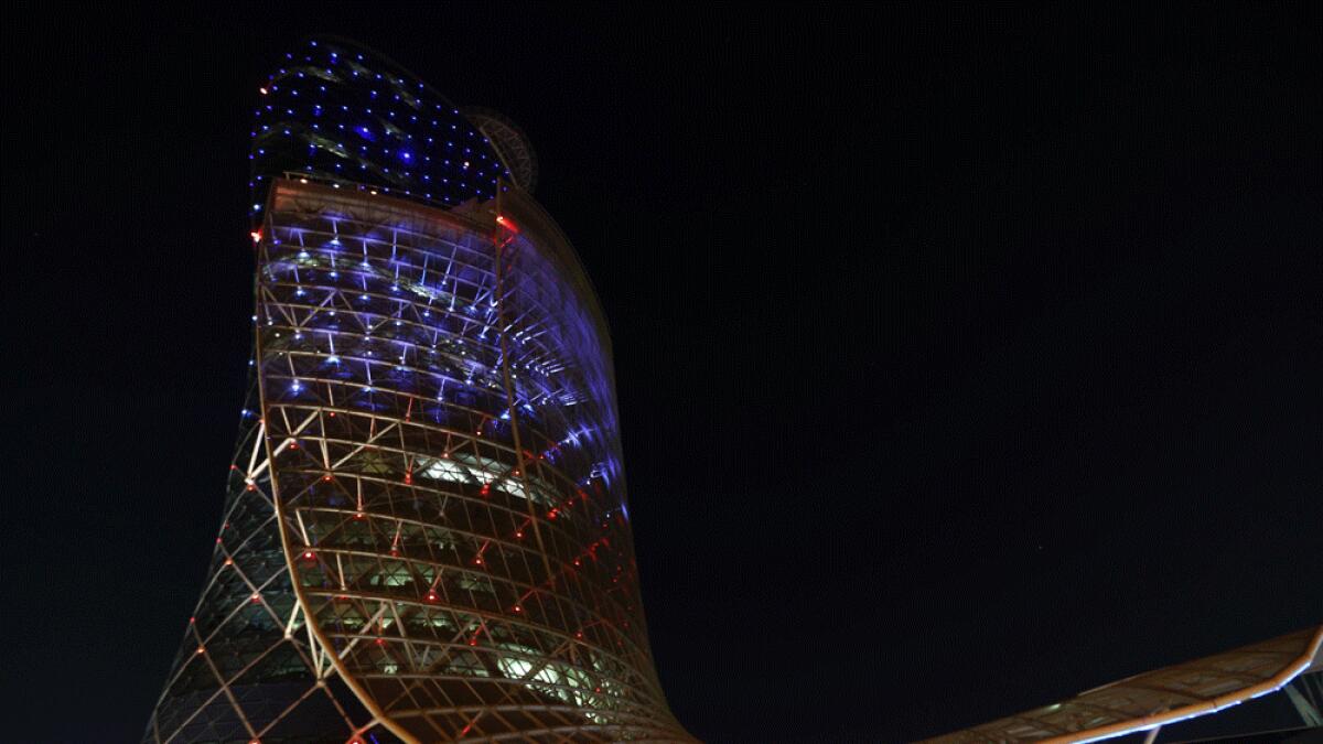 comThe ADNEC Capital Gate Building in blue, red and white.