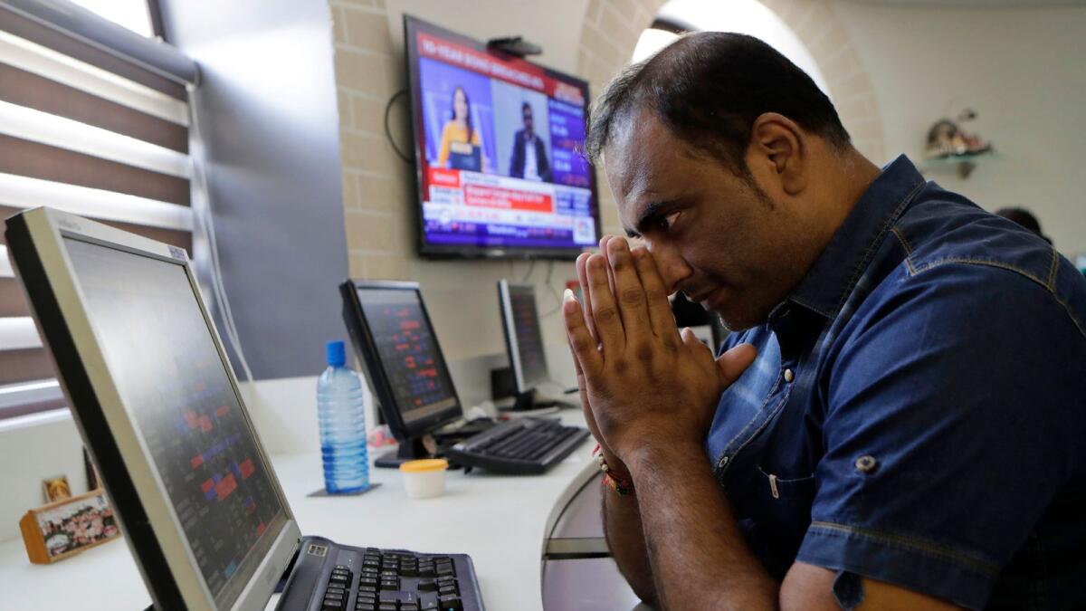 Indian stock broker watching the Bombay Stock Exchange (BSE) index on their trading terminal in Mumbai. — AP file