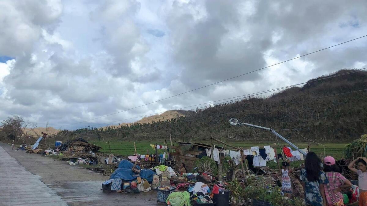 Residents gather their belongings on the side of a road after their houses were destroyed in Dapa town, Siargao Island, Surigao del norte province. Photo: AFP