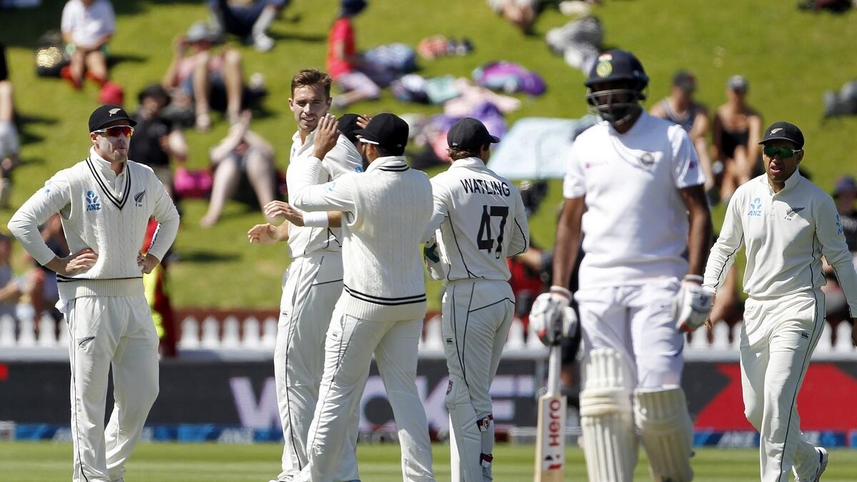DOMINANT: Tim Southee celebrates the wicket of Ishant Sharma with teammates during the fourth day of the first Test in Wellington.