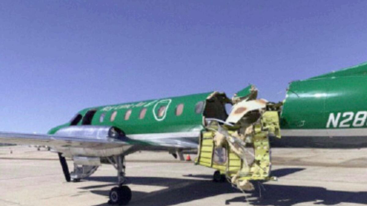 This image from CBS Denver shows a Key Lime Air Metroliner that landed safely at Centennial Airport after a mid-air collision near Denver on Wednesday. — AP
