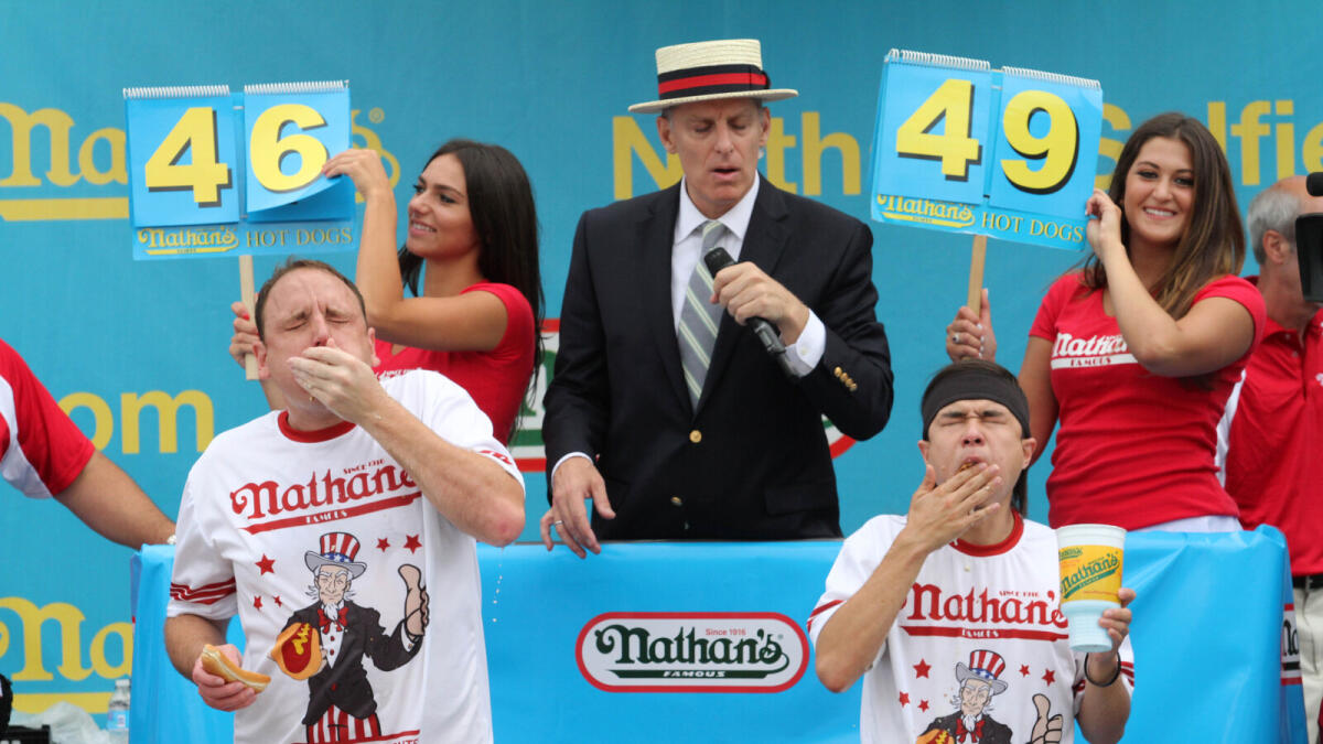 Joey Chestnut, left, and Matt Stonie compete in Nathan's Famous Fourth of July International Hot Dog Eating Contest men's competition in the Coney Island section of the Brooklyn borough of New York.