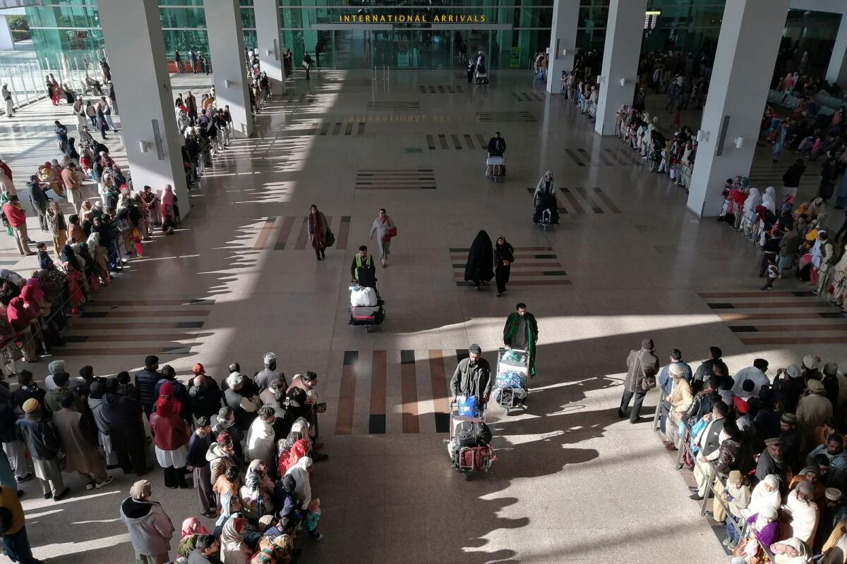 FILE. People gather to receive arriving passengers at the international arrival area of the Islamabad International Airport in Islamabad on February 3, 2020. Photo: AFP