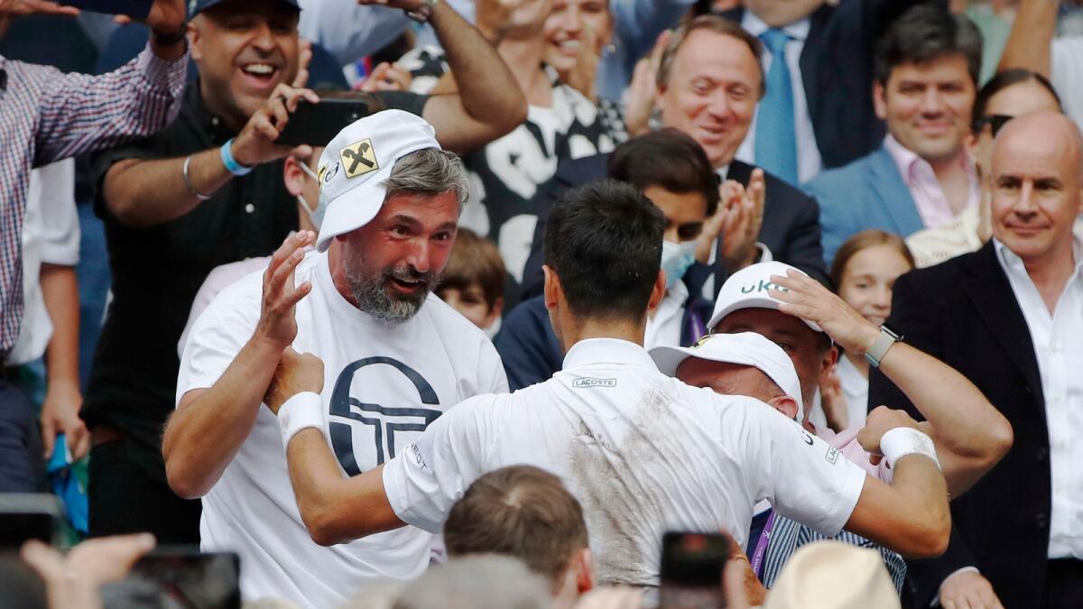 Serbia's Novak Djokovic celebrates with Goran Ivanisevic after winning Wimbledon final against Italy's Matteo Berrettini. — Reuters