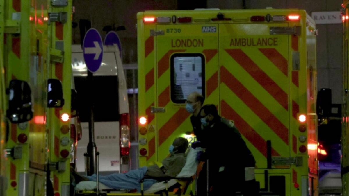 An Ambulance crew bring a patient to the Royal London hospital in London. — AFP