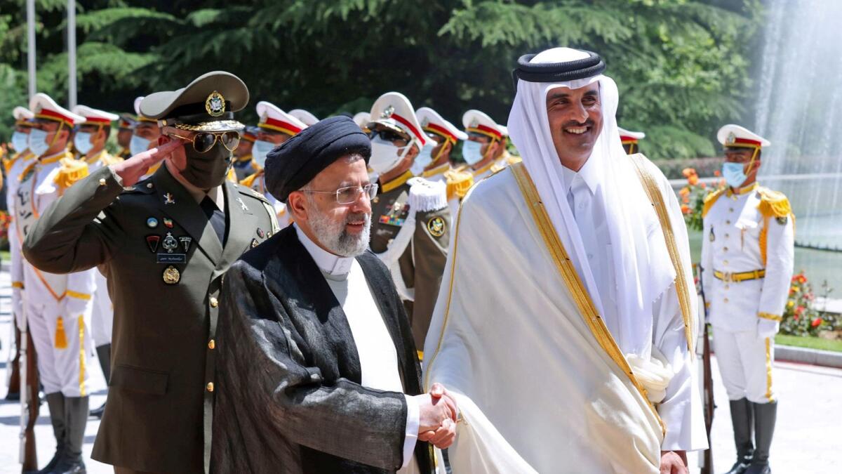 Iranian  Ebrahim Raisi welcomes Qatar's Emir Sheikh Tamim bin Hamad Al Thani at the presidential palace in Tehran. –AFP